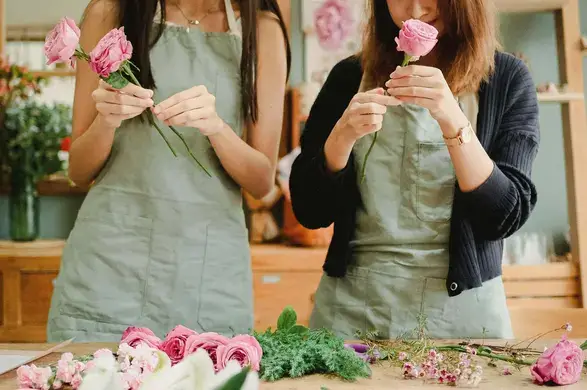 Two students learning how to work with flowers