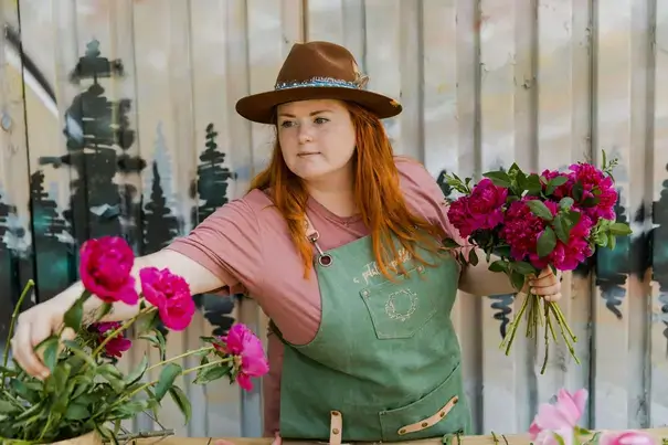 Student is choosing peonys for bouquet